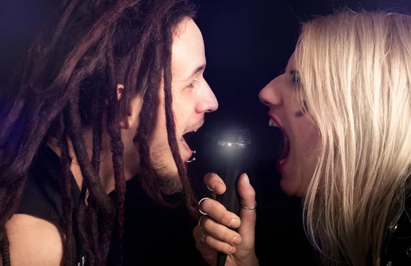 Couple singing into the microphone