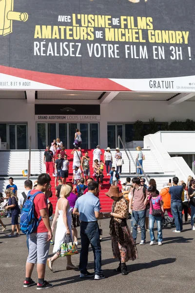People in front of the Cannes Film Festival theatre