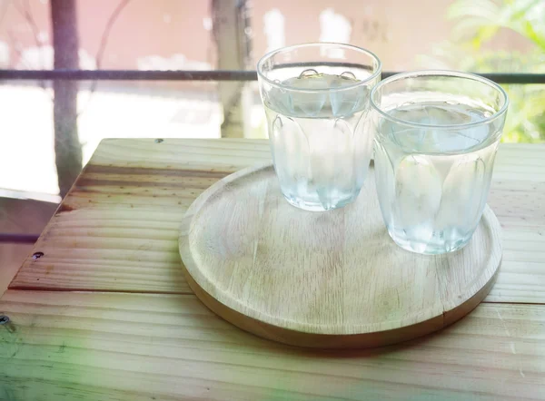 Vintage, glass of water on wood table bar.