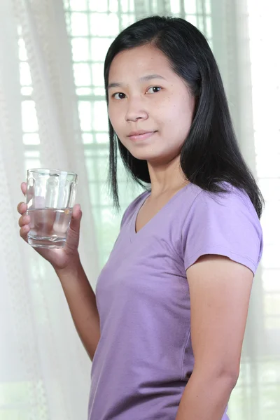 Portrait of Asian Thai woman drinking water.