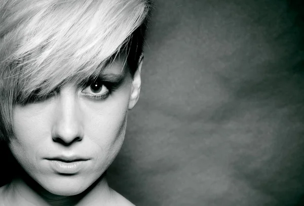 Girl with a short stylish haircut on a dark background