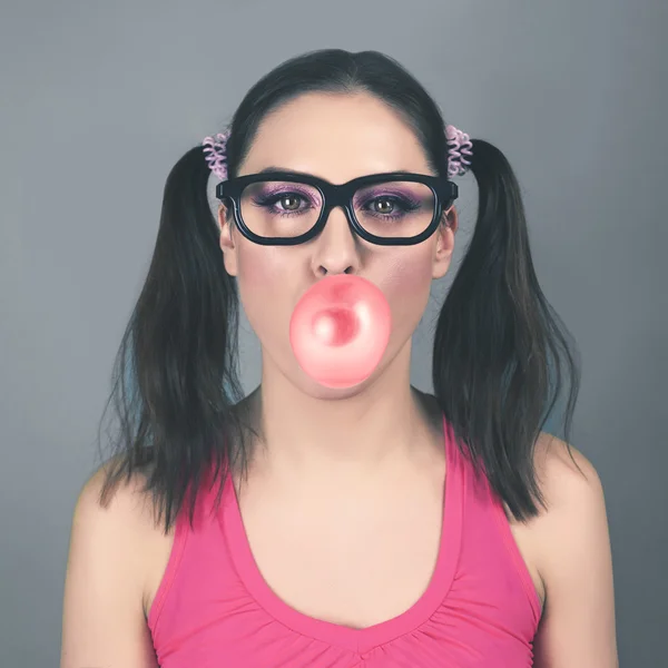 Funny girl wearing glasses with bubble of chewing gum