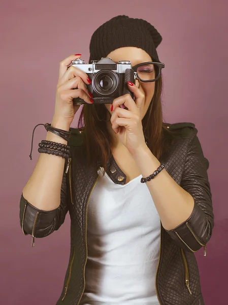 Hipster girl taking a picture with vintage camera. On green screen