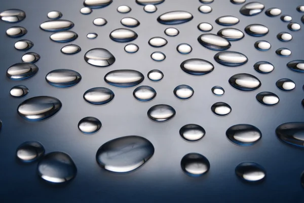 Drops of water on a dark blue gradient background