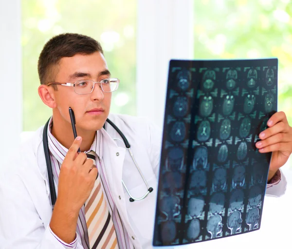 Young doctor looking at tomography brain