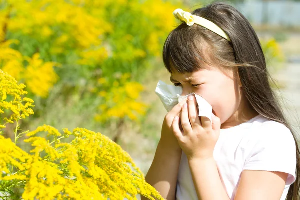 Girl is blowing her nose