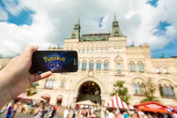 Russia, Moscow, Red Square - August 25: 2016 Smartphone with Pokemon Go application. An Android user plays , a augmented reality mobile game developed by Niantic for phone