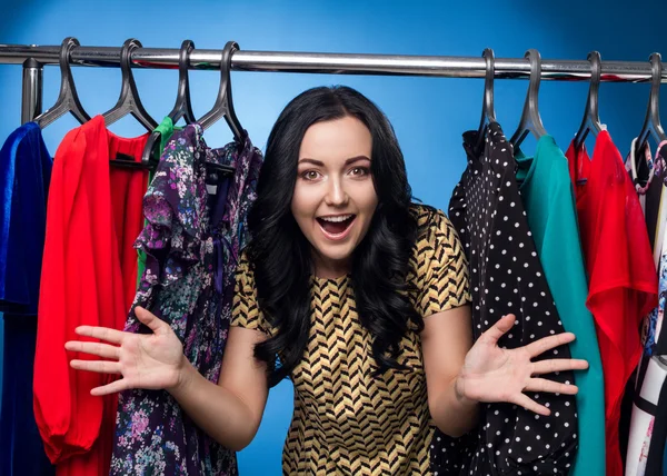 Happy Woman At The Clothing Rack With Dresses