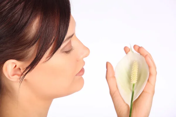 Close-up image of a beautiful woman holding flower in spa