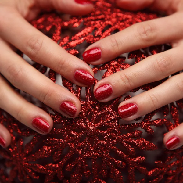 Beautiful woman\'s nails with beautiful christmas manicure
