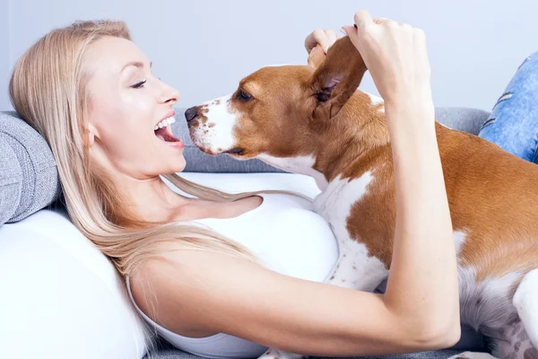 Happy blonde girl with beagle.