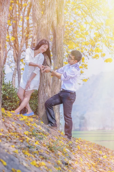 Asia happy couple standing under tree