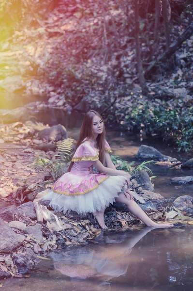 Asia beautiful girl in ballet dress on nature