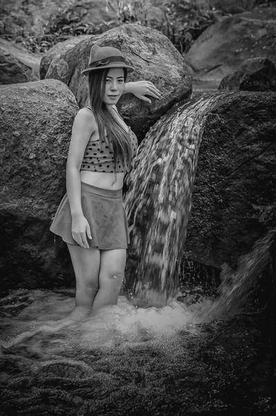 Asia Beautiful young girl stand in water fall