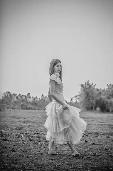 Asia Beautiful woman in yellow dress stand on field