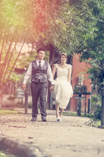 Asia young stylish fashion couple posing on nature.