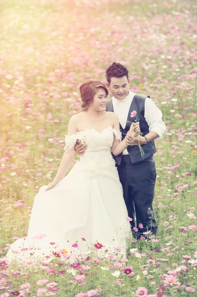 Asia young stylish fashion couple posing on nature.