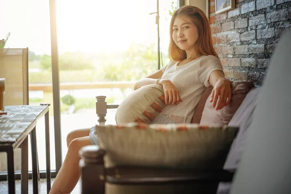 Asia Attractive woman sitting on the couch