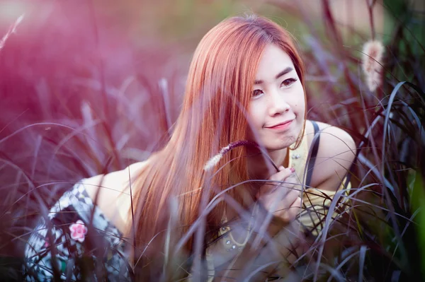 Portrait smile asia Beautiful girl sit on grass