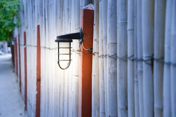 Outdoor Wall Lamp on bamboo fence