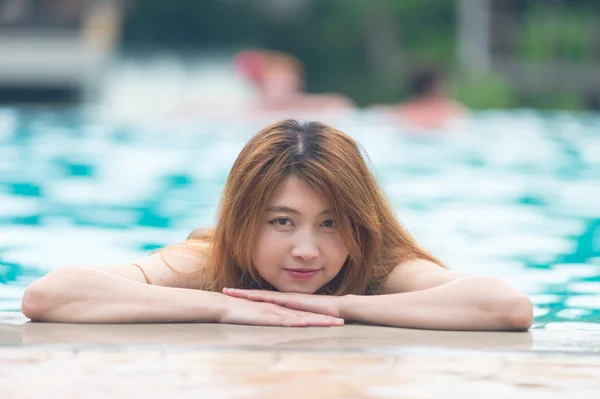Asia beautiful Woman at the Edge of Swimming Pool