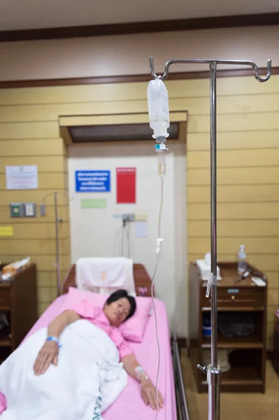 Asia woman patient with saline intravenous (iv) drip