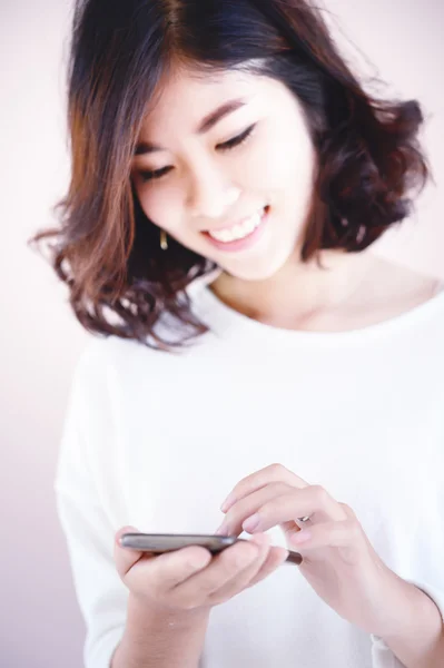 Asia happy young woman with her smart phone