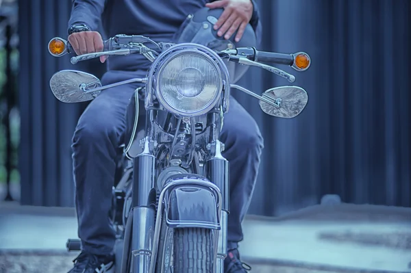 Biker man sitting on his motorcycle, vintage effect