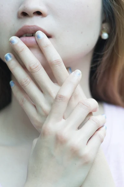 Close-up of beautiful face women and manicured fingers