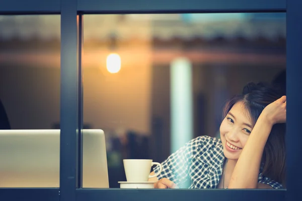 Asia happy woman sitting at bar table on relax day