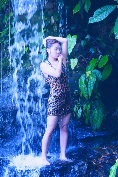 Asia sexy girl under relaxing hot waterfall