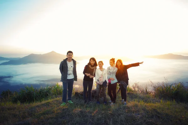 Sunrise on misty  mountain with women and man