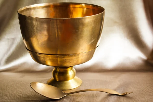 Antique brass bowl and ladle, still life art photography on vint