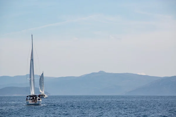 Sailing boat in the adriatic ocean, Croatia. Mountains on the horizon.