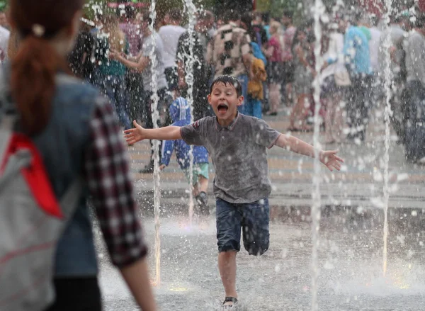 KHARKIV, UKRAINE - JUNE 1, 2015: Teenage girl playing in fountain