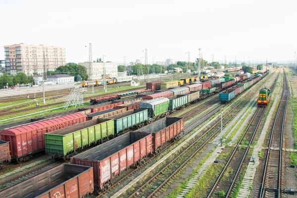 Big railway cargo and passengers  station junction with lot of trains and track lines.