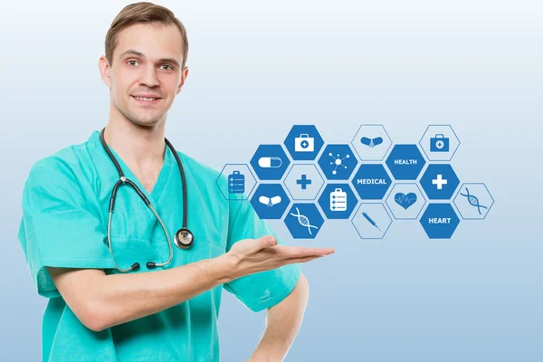 Healthcare, profession, symbols, people and medicine concept - smiling male doctor  in coat over blue background with medical icons