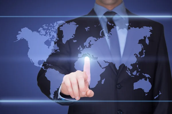 Business, technology, internet and networking concept - businessman pressing button with contact on virtual screens. World map