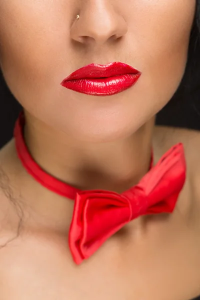 Close-up of bright red lips, tied around his neck the bow tie