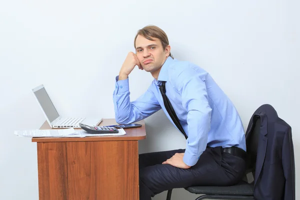 Disgruntled manager at his desk.