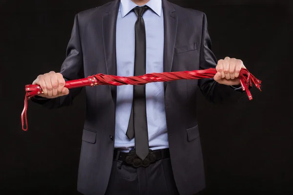 Man in business suit with chained hands. handcuffs for sex games