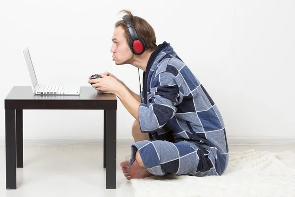 Man in bathrobe playing on a laptop