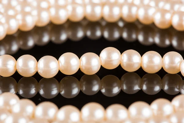 White pearls on  black  background. luxury necklace.