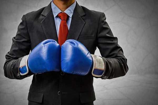 Businessman wearing boxing gloves