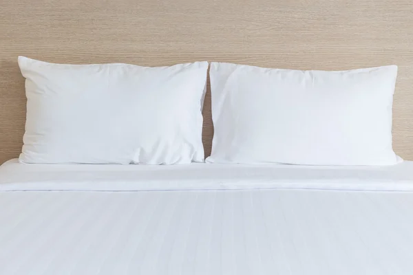 White bedding sheets and pillow in hotel room