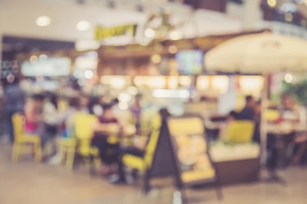 Blurred image of people in coffee shop with bokeh, vintage color