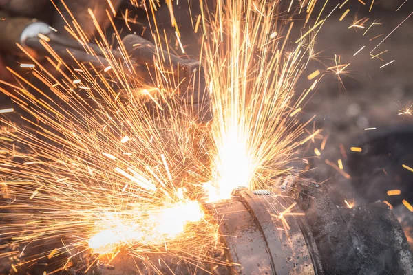 Worker cutting steel using metal torch