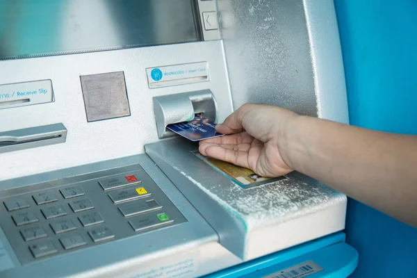 Woman's hand using the ATM