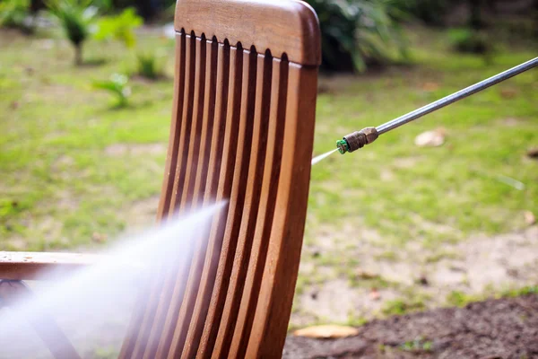 Wooden chair cleaning with high pressure water jet