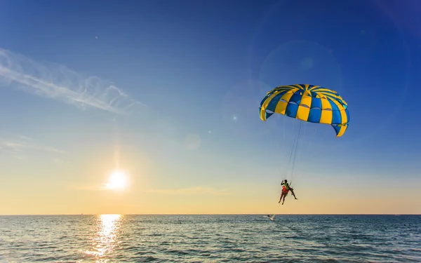 Tourist is para sailing over the blue sea